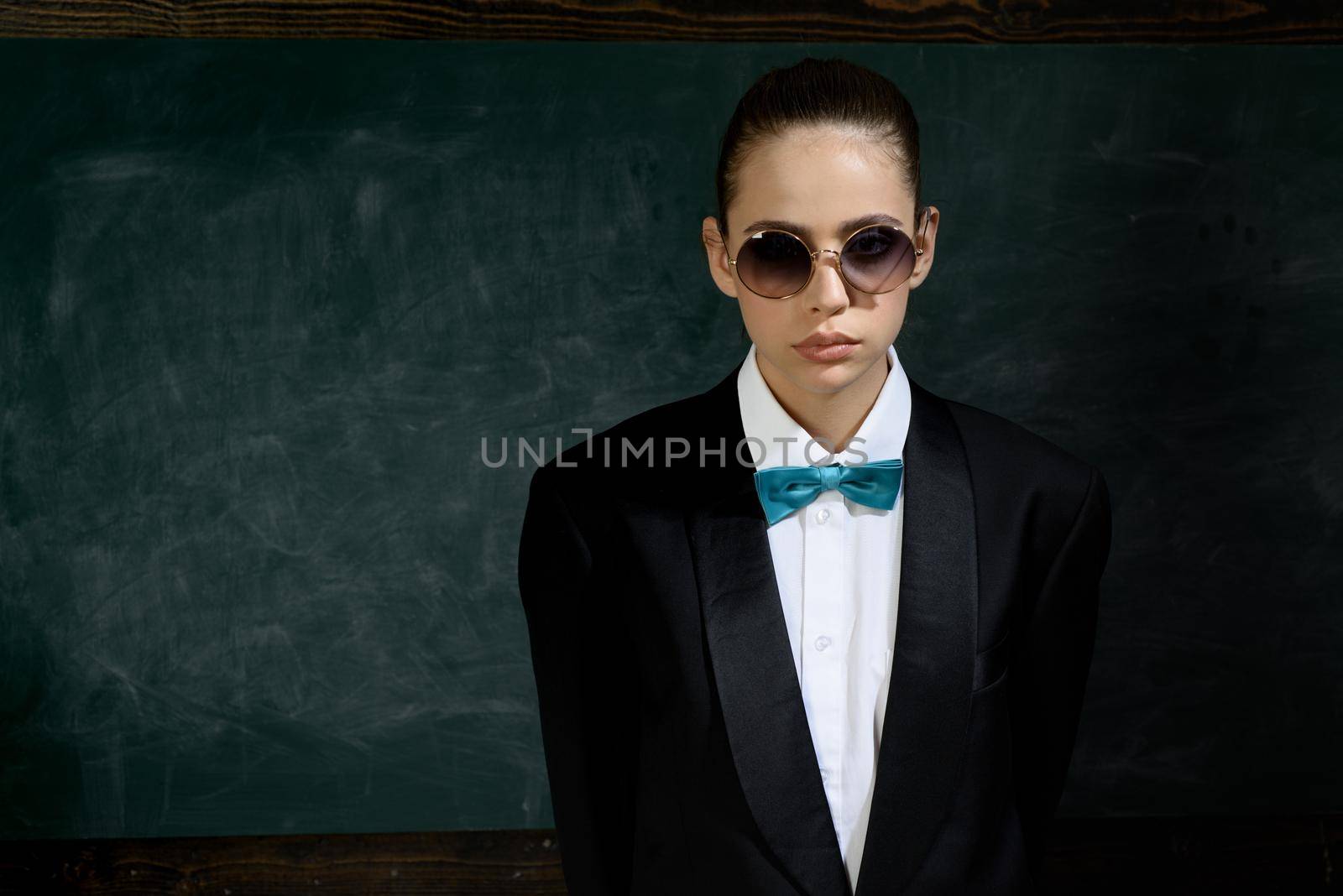 Woman wear masculine clothes tuxedo bow tie and eyeglasses. Sunglasses formal style. Girl formal jacket suit and sunglasses copy space. Fashion trend. Stylish sunglasses accessory. Fashion outfit.