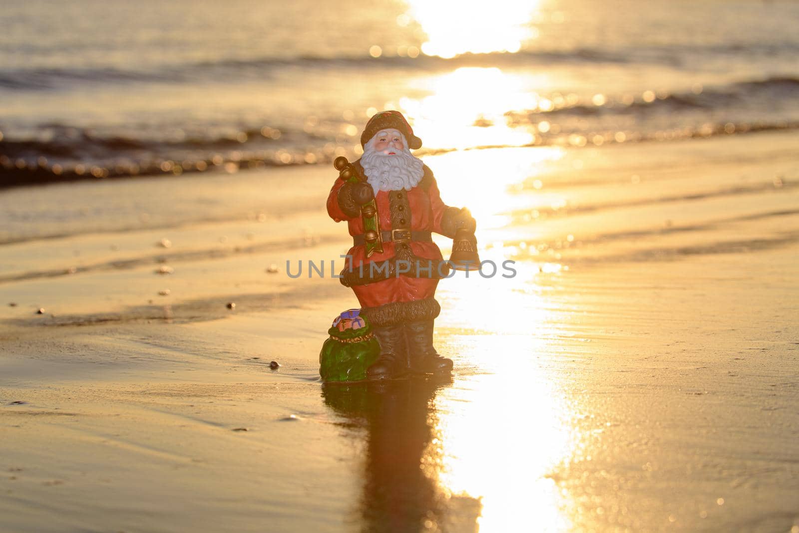 Summer Santa on sand sunset . Holiday concept for New Year and Christmas