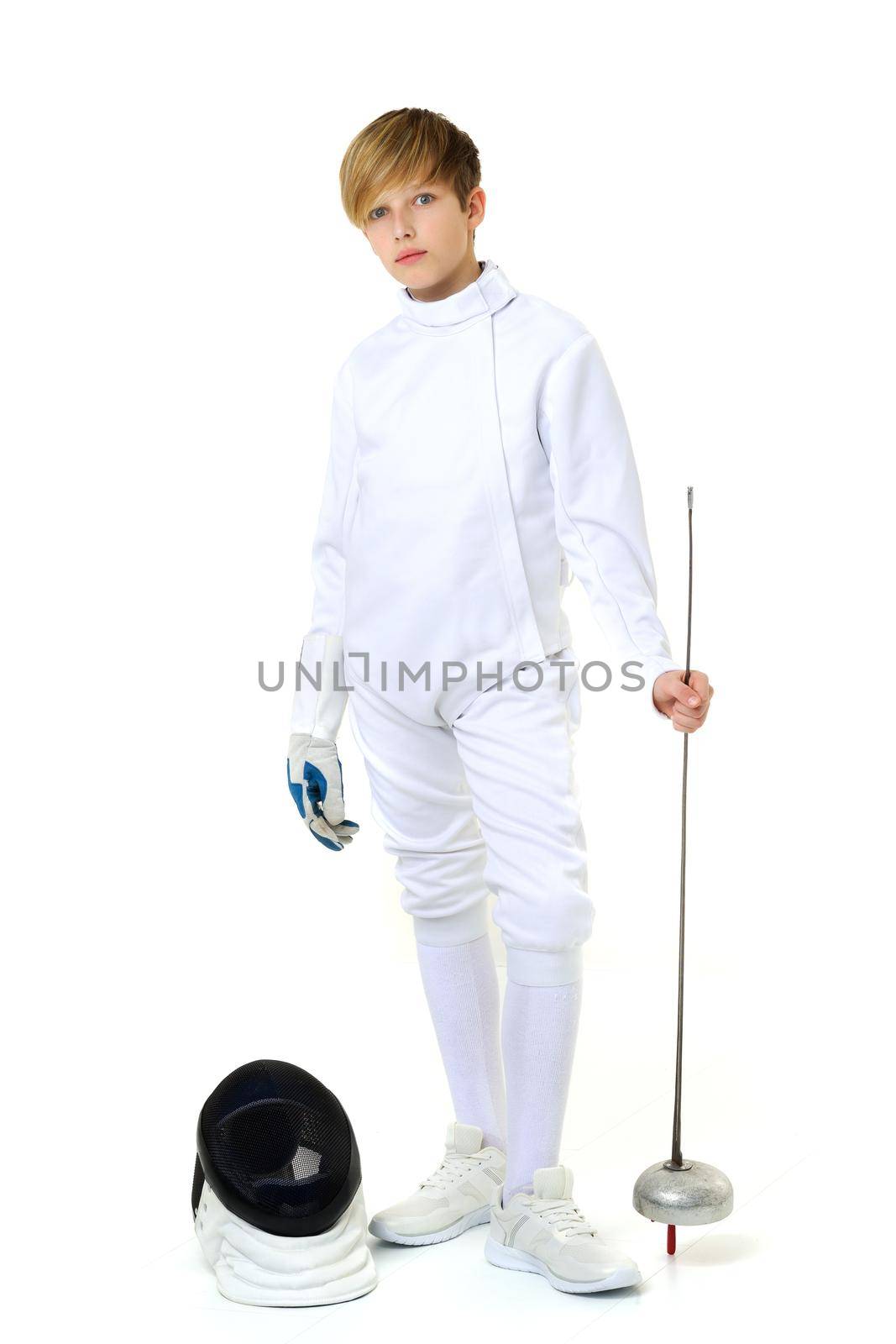 Boy in fencing costume posing with sabre and mask by kolesnikov_studio