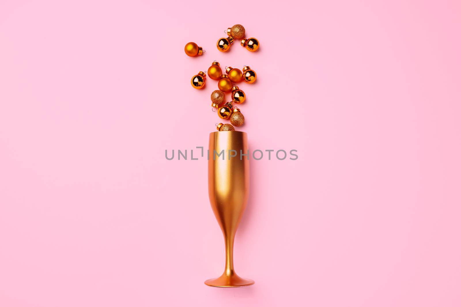 Champagne glass with Christmas balls flat lay by Fabrikasimf