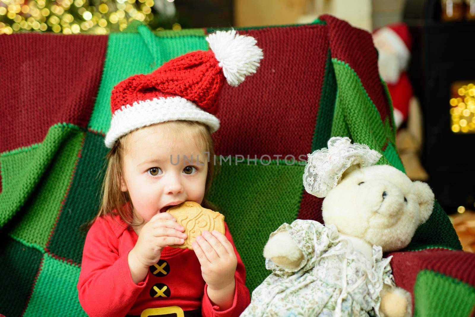 Christmas funny portrait of cute little baby in santa hat. by Tverdokhlib