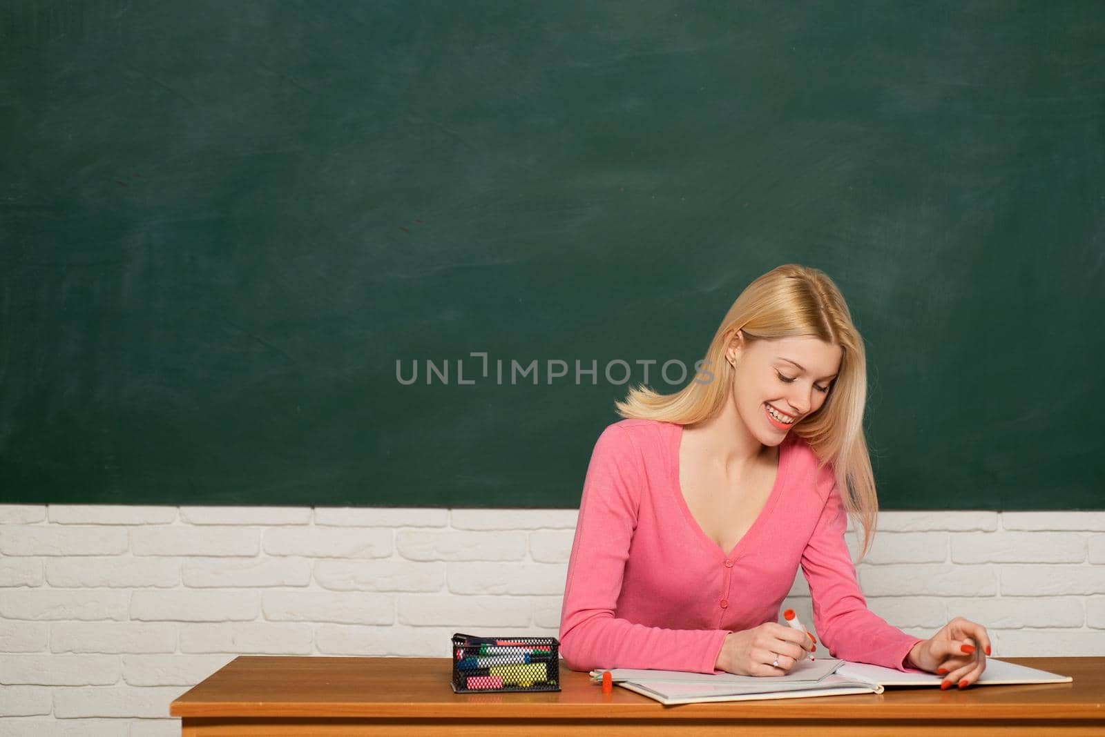 Girl adorable teacher sit classroom chalkboard background copy space. School education. Formal education. Woman student study with creativity and fresh ideas. College education. Education concept.