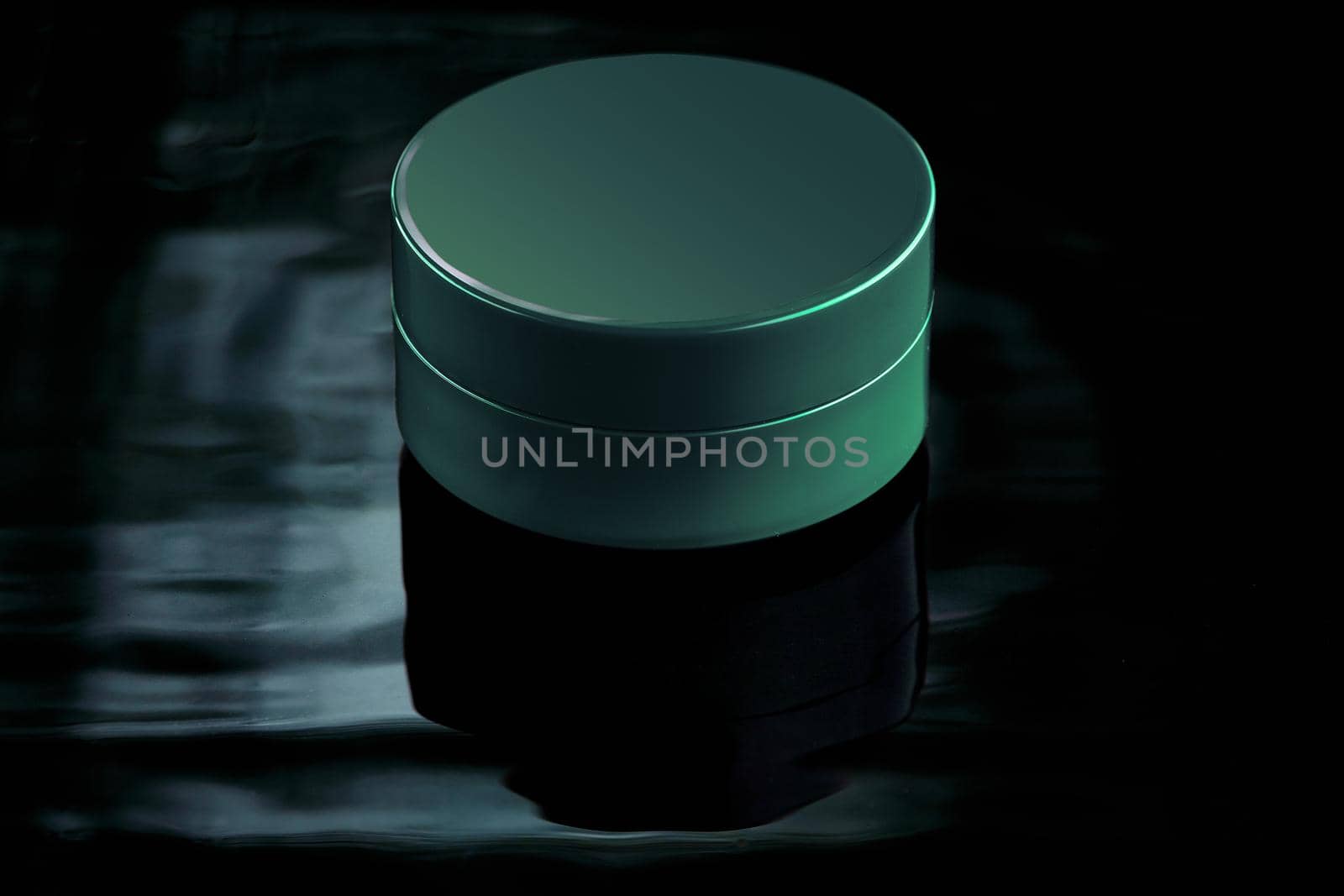 A small jar of emerald color in water with reflection on a dark background. Mockup for advertising cream, lation, moisturizing milk or body and face care products