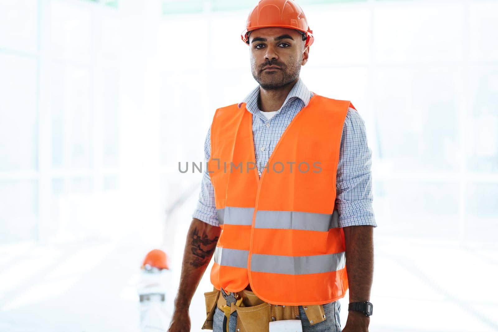 Portrait of young construction engineer wearing hardhat by Fabrikasimf