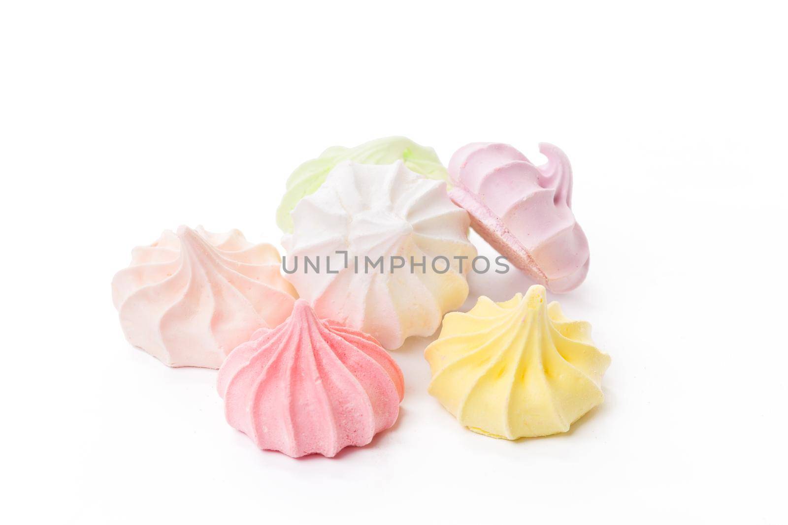 Pile of colorful meringue cookies isolated on white background