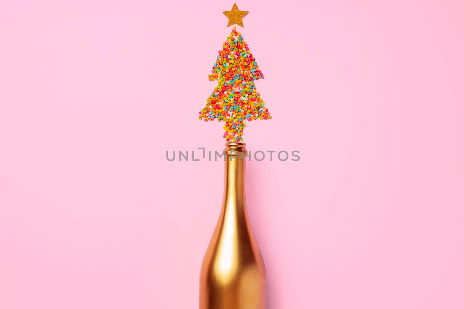 Champagne bottle with confetti flat lay top view, christmas background