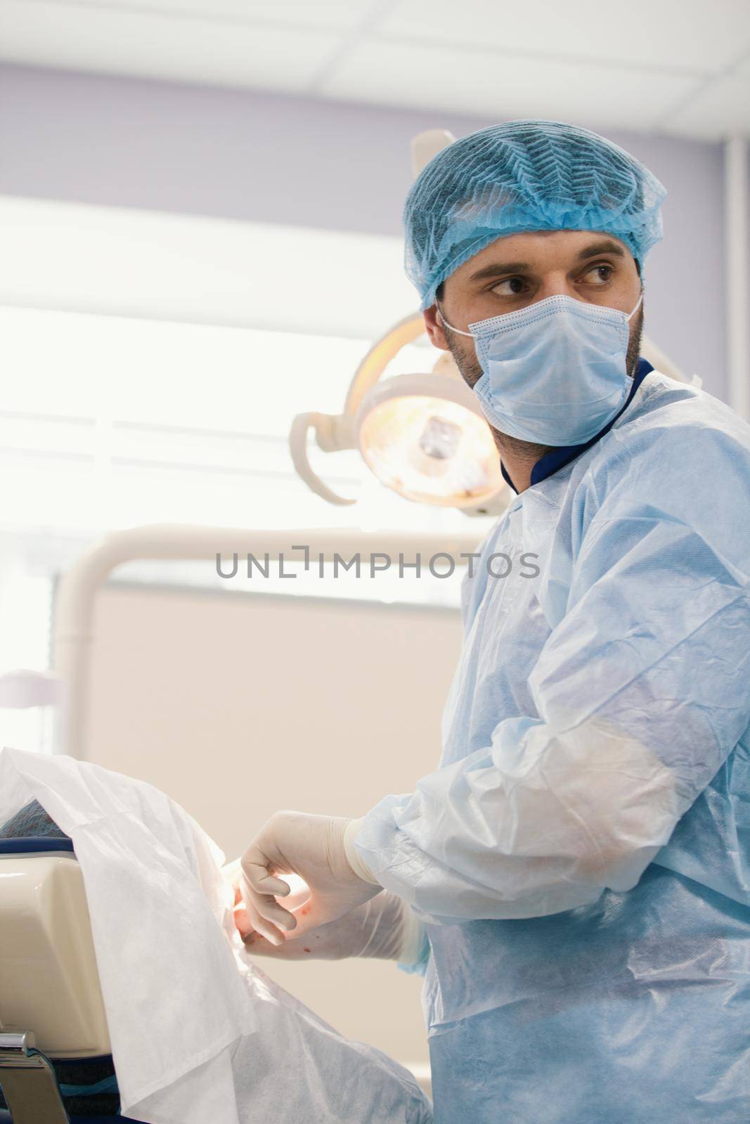 Doctor surgeon during stomatology surgery in dentistry room, close up