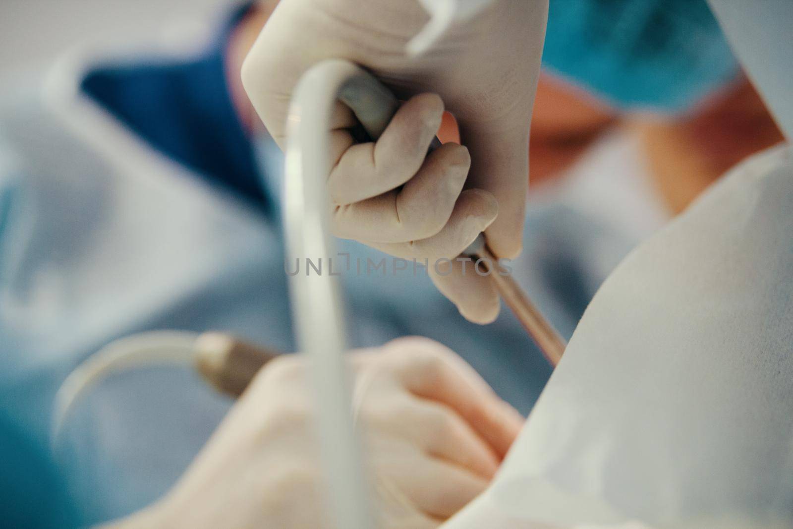 Surgeons in surgery room makes medical operation for patient, close up