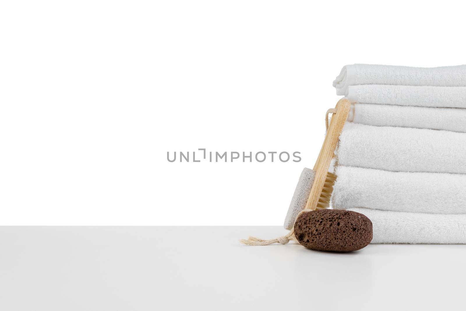Spa still life with stacked of stone and towel isolated on white by Fabrikasimf