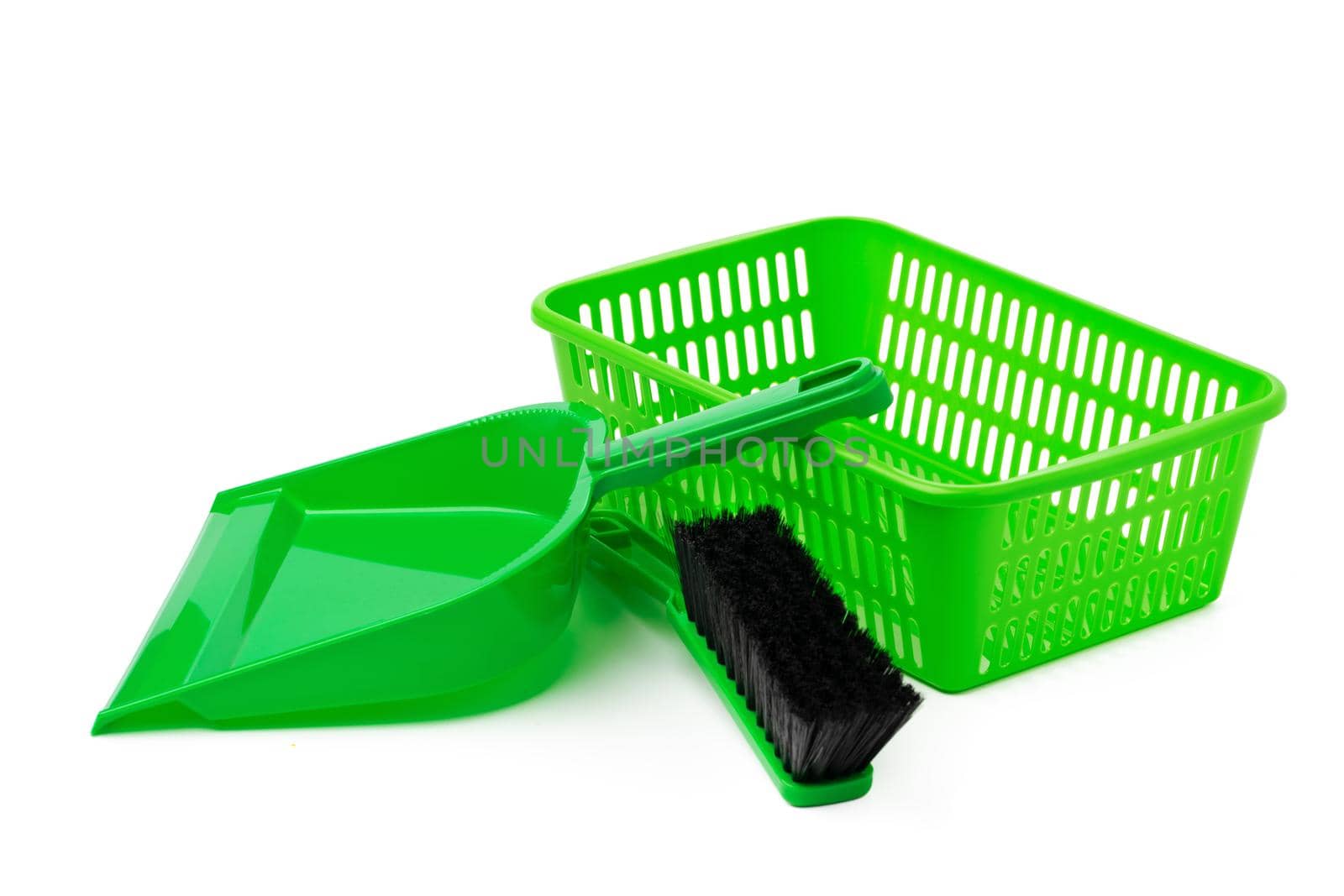 Green plastic basket and scoop isolated on white background, close up