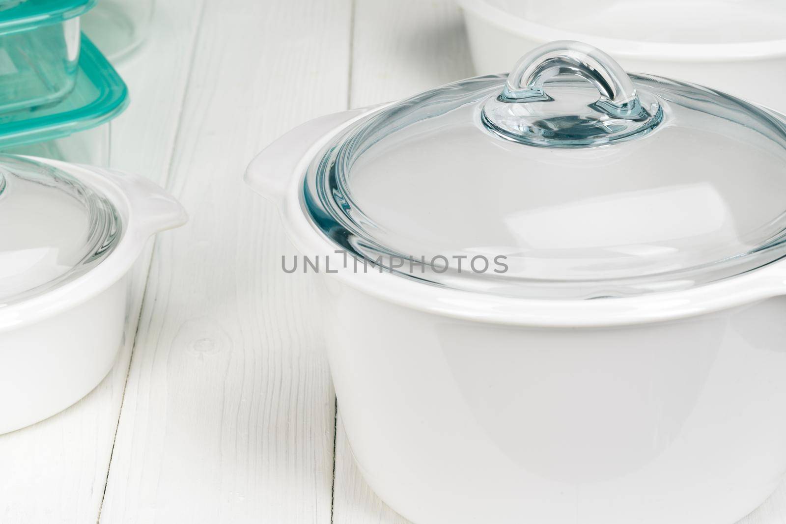 White pot cookware in a kitchen interior. Close up.
