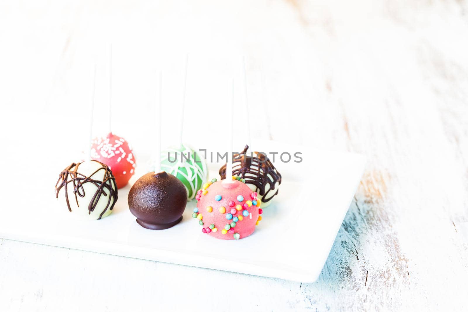 Cake pops close up on the white plate