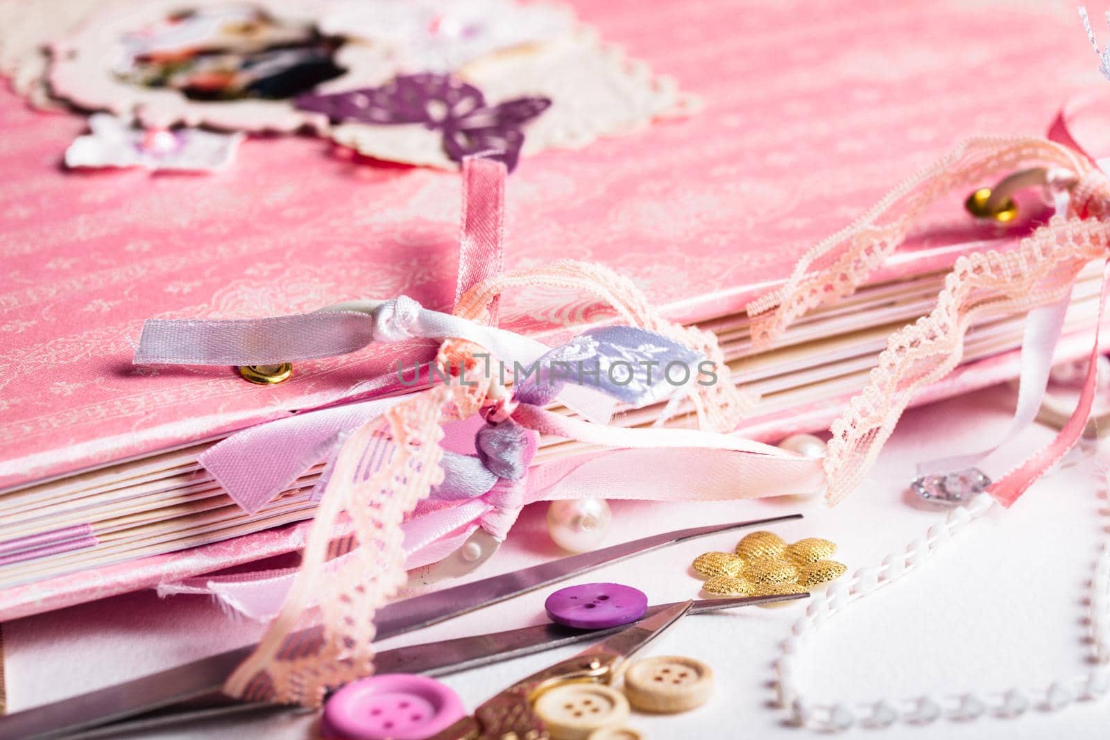 Making scrapbooking album with rings and decorations on the table and tools