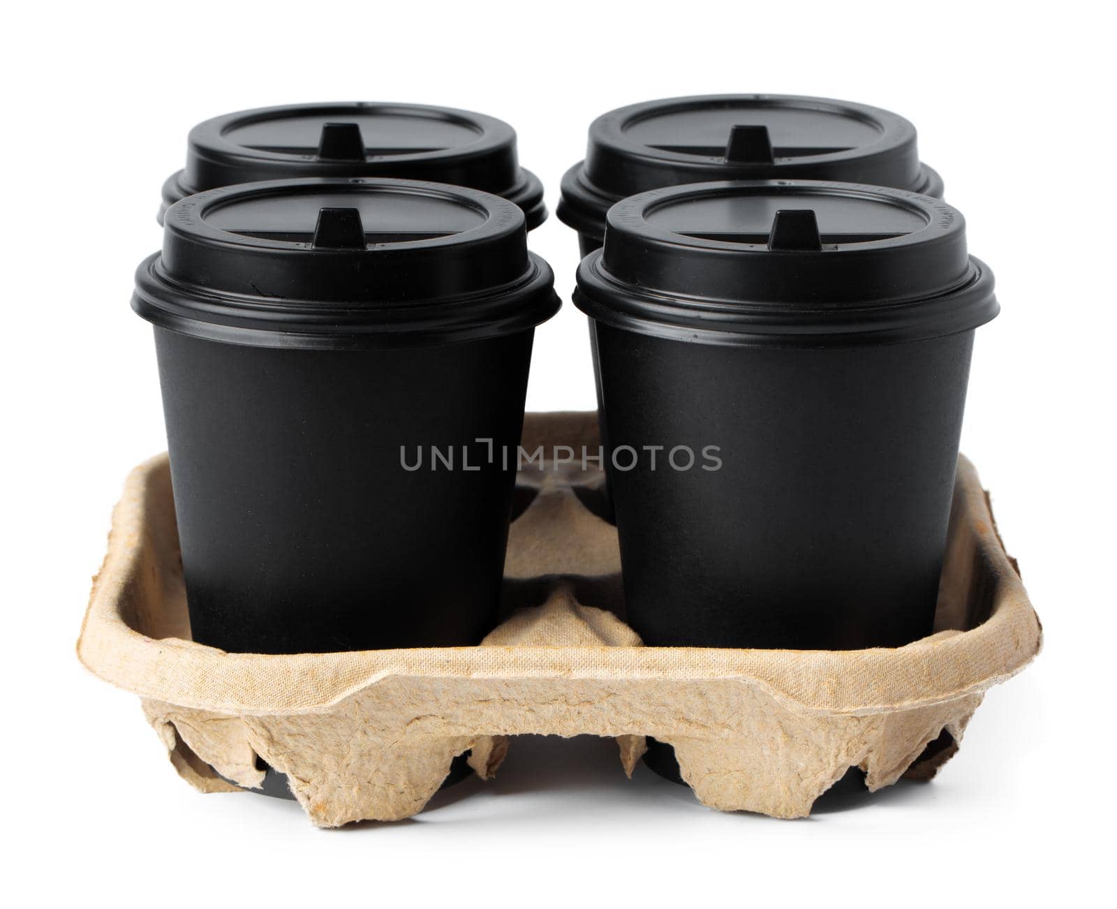 Four takeaway coffee cups in a tray isolated on white background