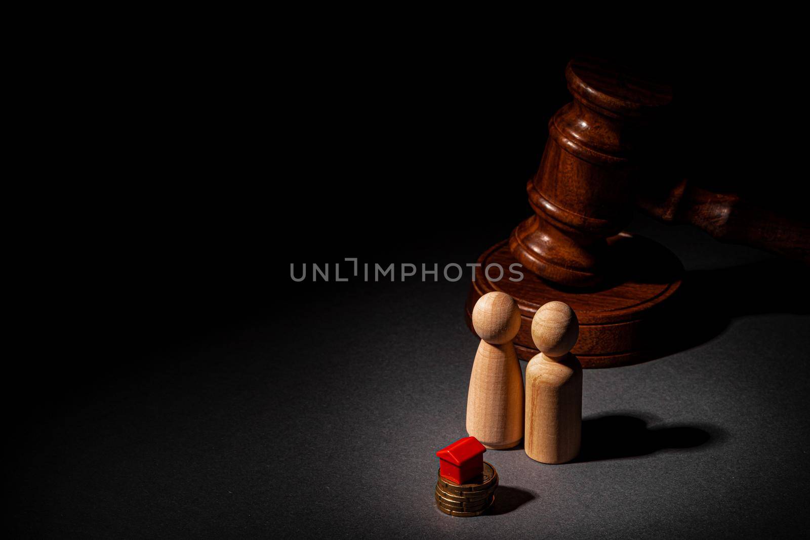 Divorse property division concept. Wooden family with house and judge gavel close up