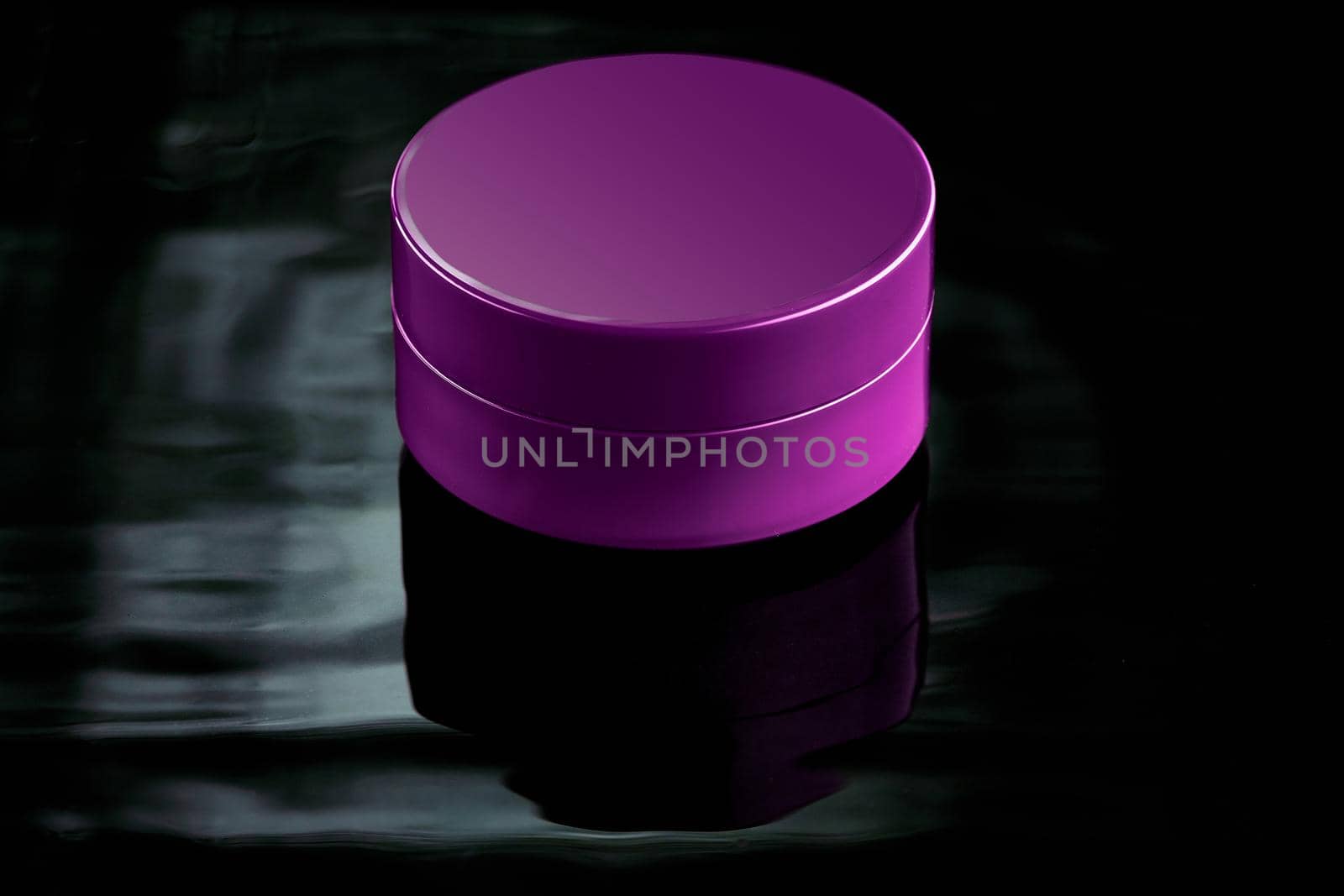 Pink plastic jar in water on a dark background. Mockup for advertising cosmetics and body care products. Layout of a moisturizer, milk or balm
