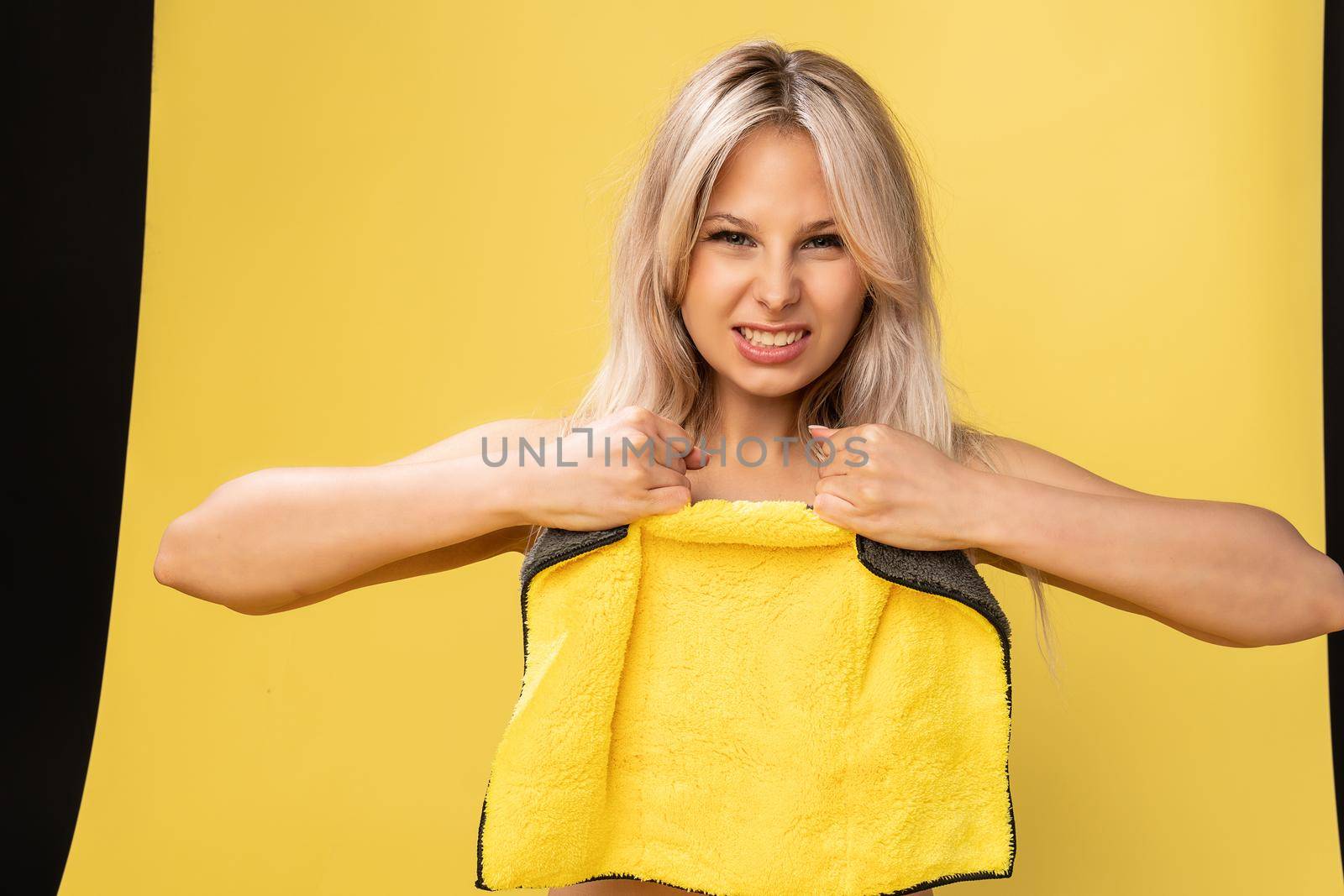 Girl rips rag with her hands yellow on a yellow background beautiful blonde dust tidy cleanup, rubber protective childhood clean virus, cleaner domestic. Interior copy surface, hand around duties by 89167702191