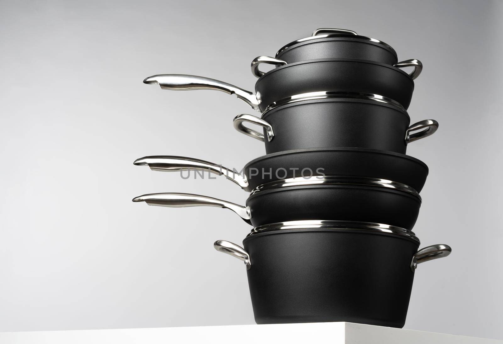New domestic cookware on grey background close up front view