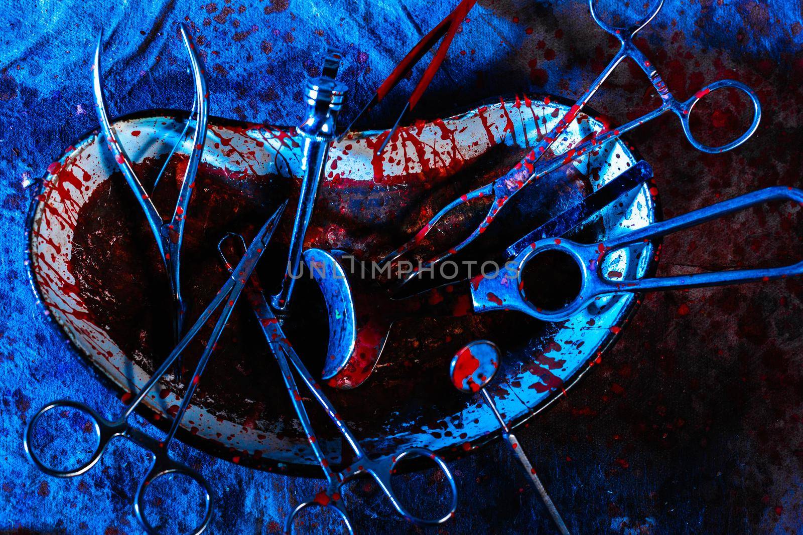 Dirty bloodstained medical utensils and tools on a gloomy table. The concept of illegal abortions at home. The old medical method of terminating pregnancy