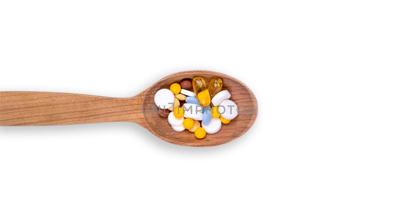 Medicine, pills and drug in wood spoon on white background with copy space.