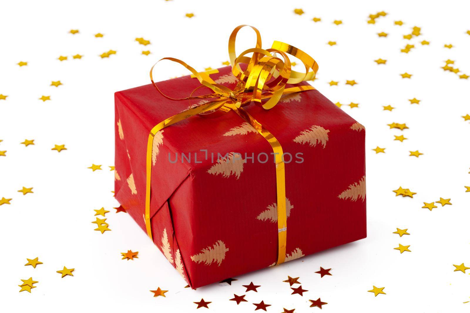 Christmas present gift box with confetti isolated on white background, close up