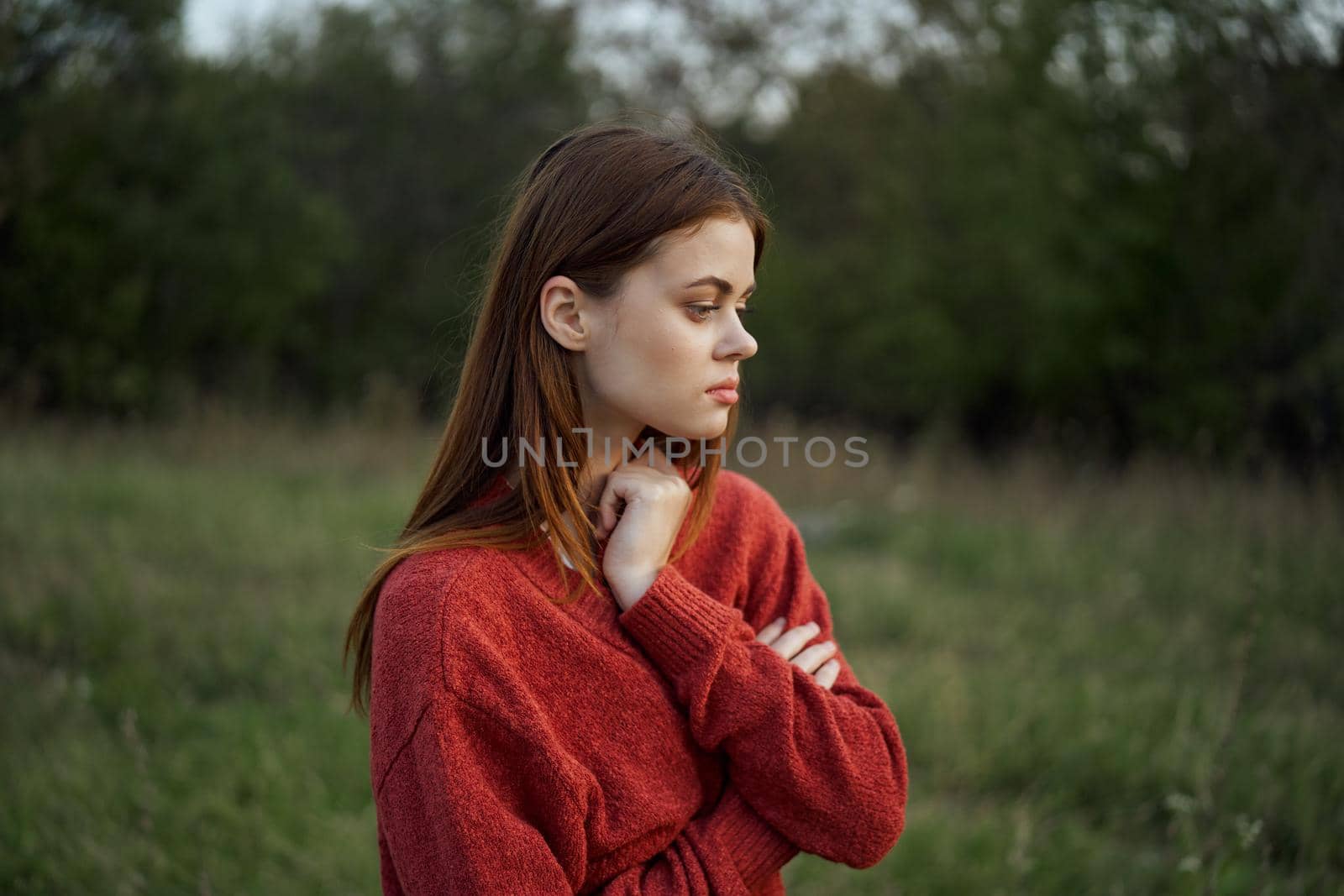 woman in a red sweater outdoors in a field walk by Vichizh