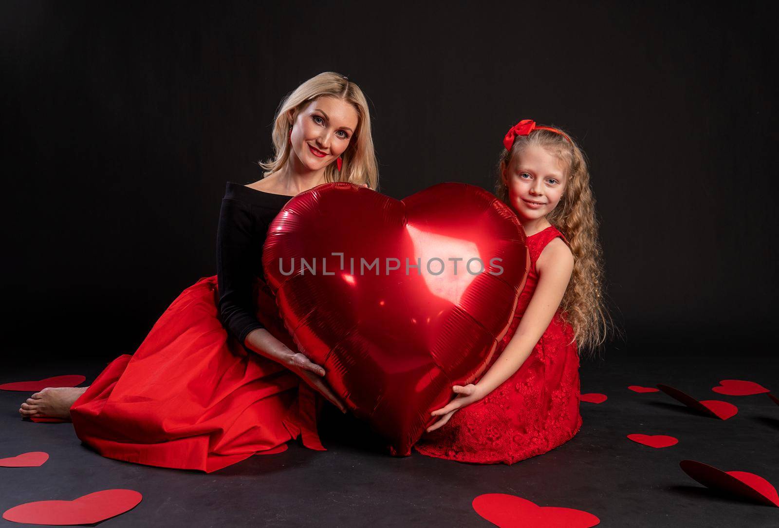 Girl and child hold a ball heart symbol, happiness flirting, on the floor hearts married layout. form a holiday. Dream Forever, Black in Red Girl Dress, Barefoot by 89167702191