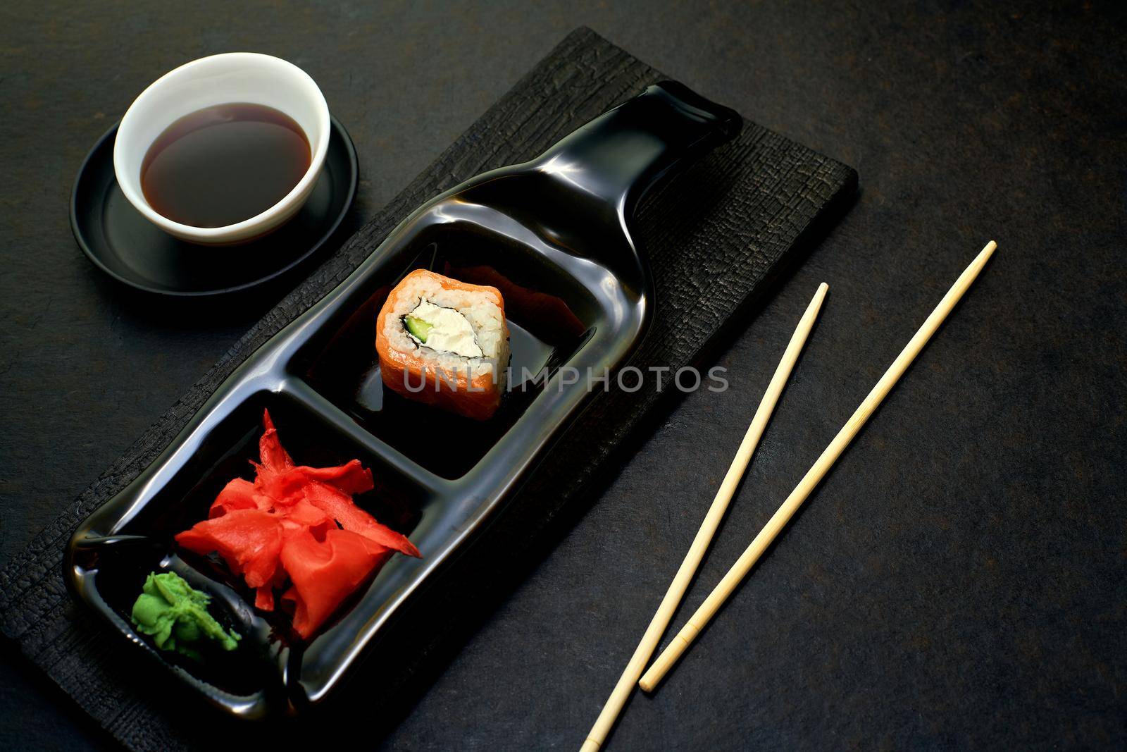 Sushi rolls top view. Stylish minimalism in the menu. Serving rolls to the client in a dark style. by SergeyPakulin