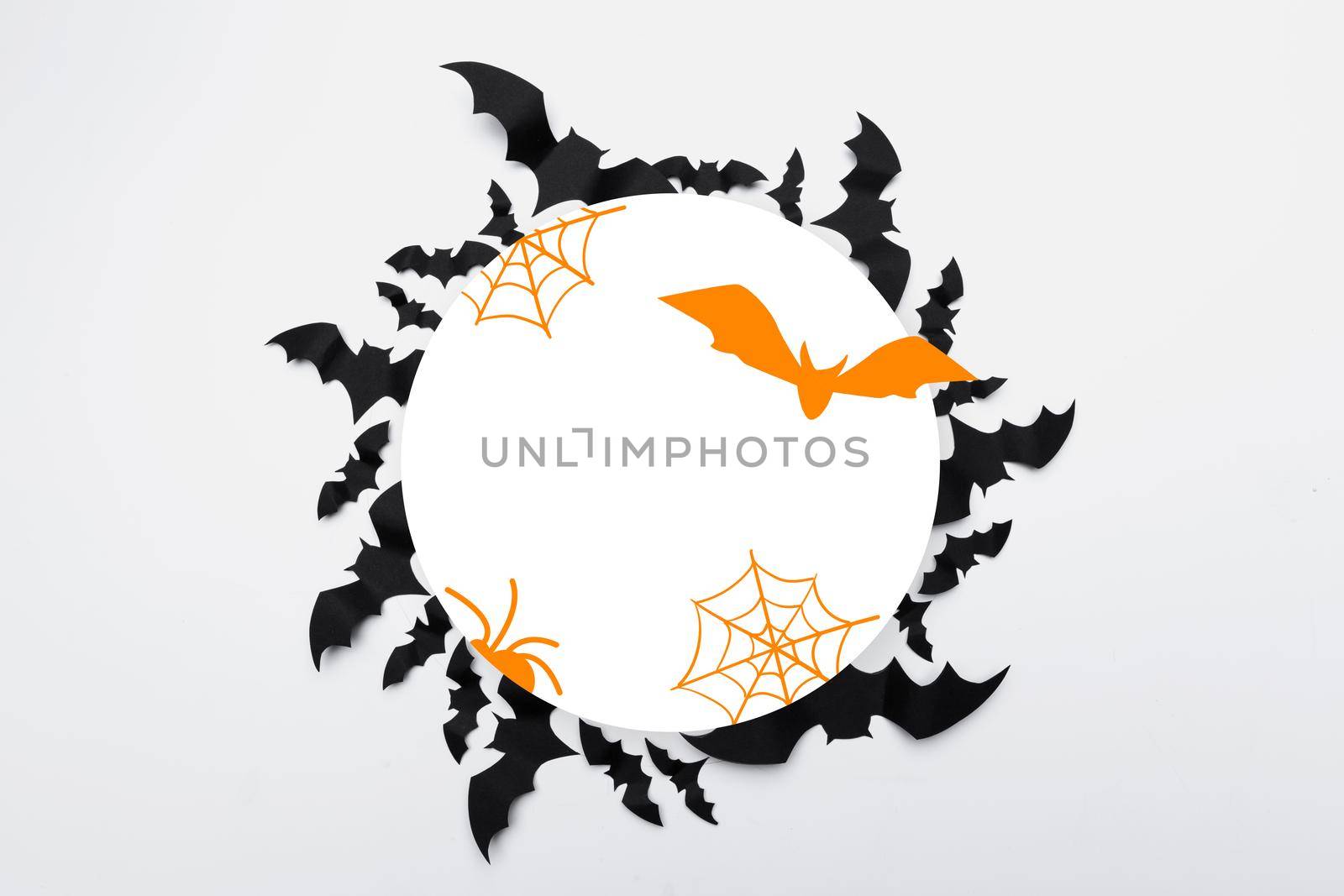 Halloween concept - black paper bats on white background