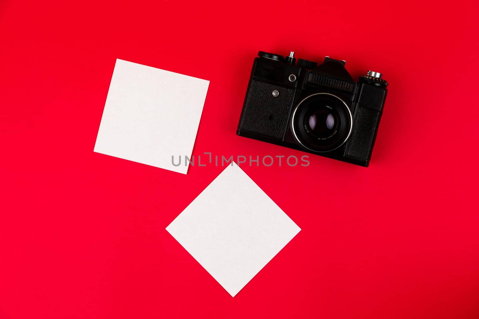 Flat lay film camera isolated on red background. Copy space