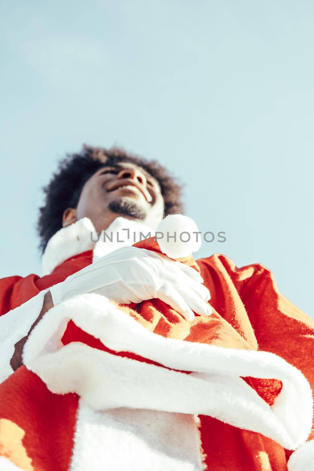 View from below of happy afro santa claus