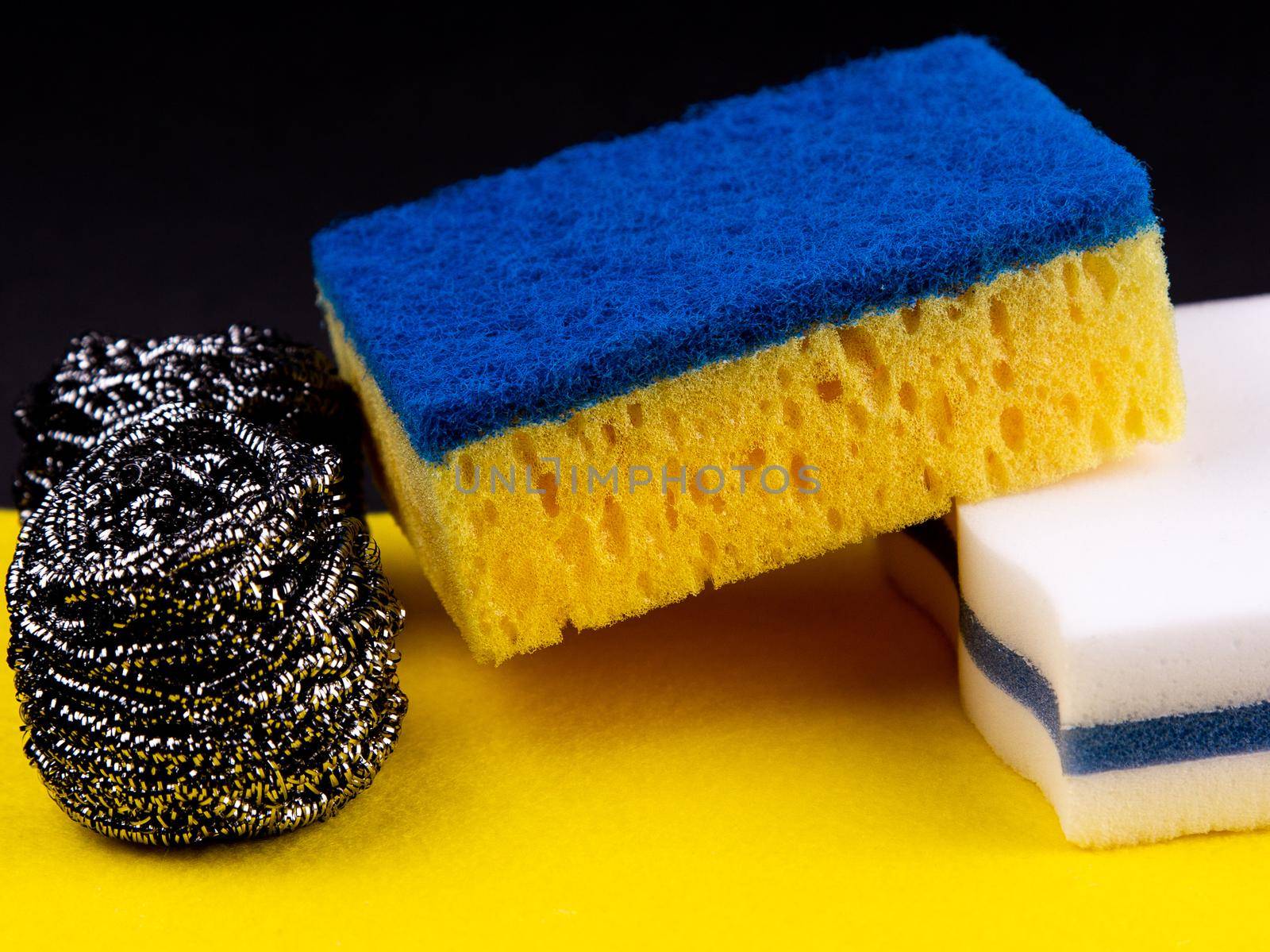 Dishwashing concept. On a black background, different washcloths and scrubbers for washing dishes.