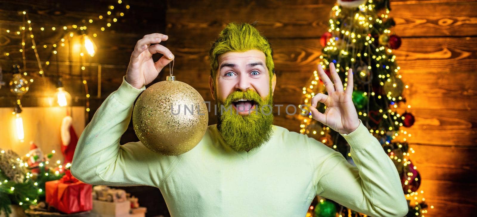 Santa man with a white beard posing on the Christmas wooden background