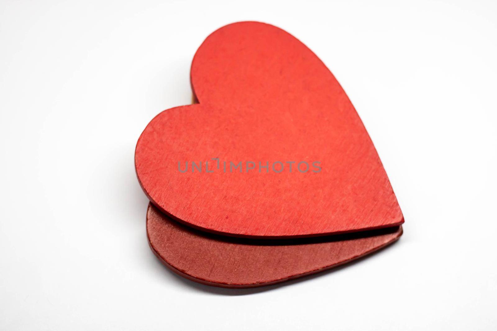 Two red wooden hearts on a white background. Concept cards for Valentine's Day, March 8, and mother's Day. Medicine and health.Space for text.