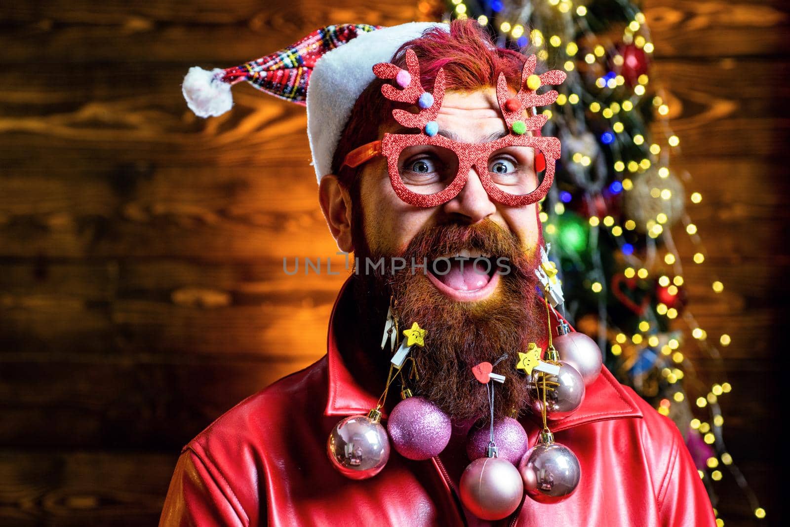 Merry Christmas and happy New Year. Christmas face of bearded santa. Christmas people celebration New Year. Portrait of a funny Santa Claus. by Tverdokhlib