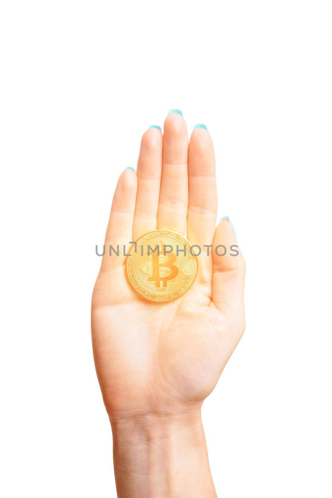 One glowing gold bitcoin on female palm hand on a white background, symbol of virtual money.