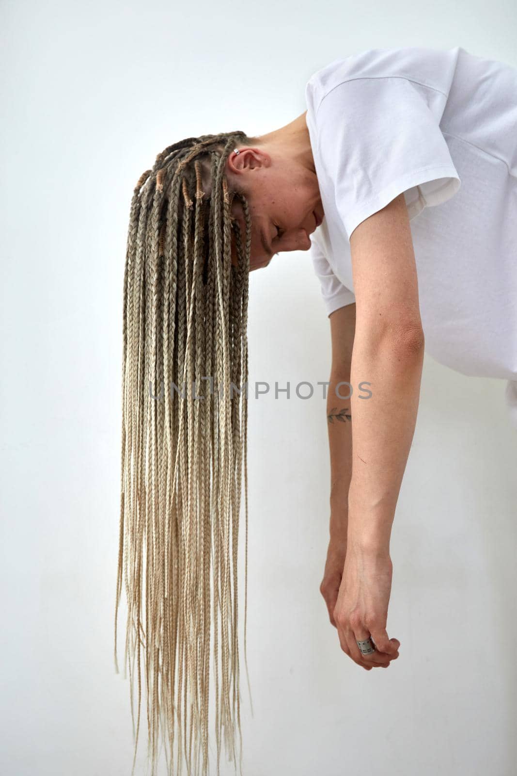 Woman with long braids bending head down by Demkat