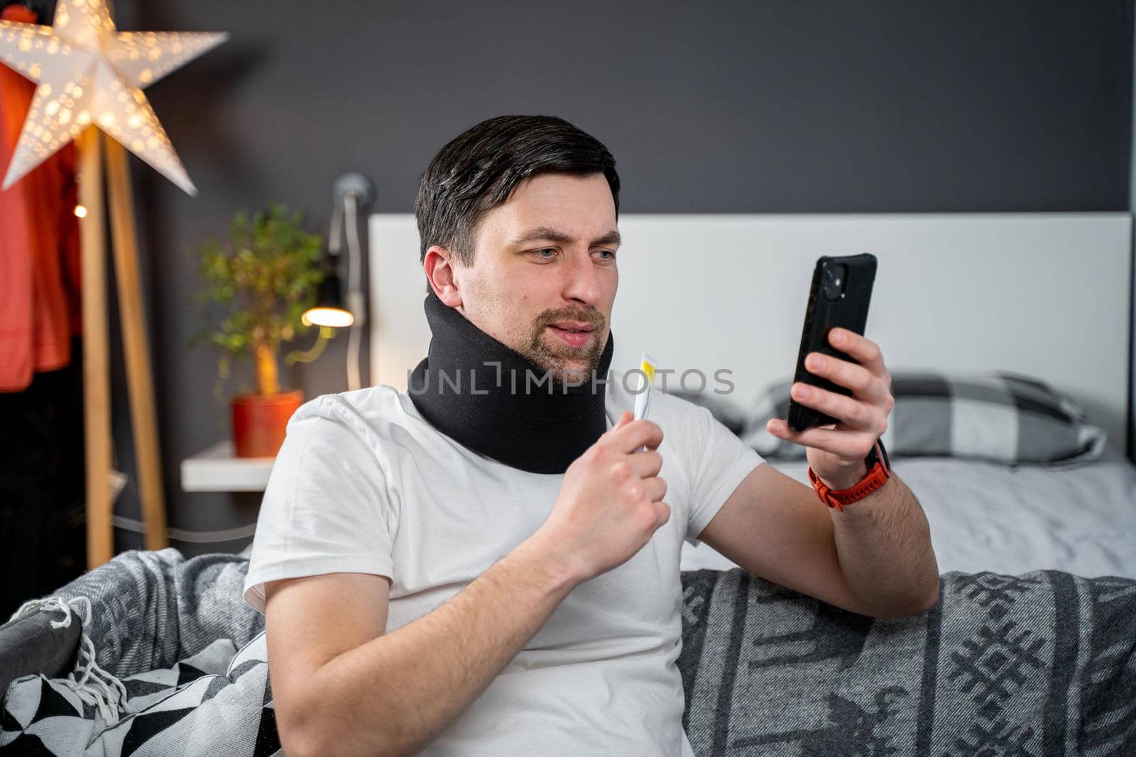 Topic online consultation with doctor. Man with neck collar complains of neck pain after an injury and asks for stronger medication from health care provider during video communication conference.