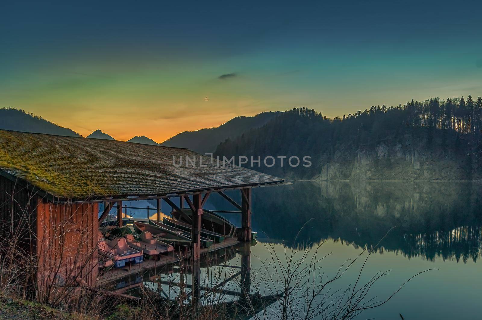 Lake house with a little pier in front of the mountains. by AllesSuper