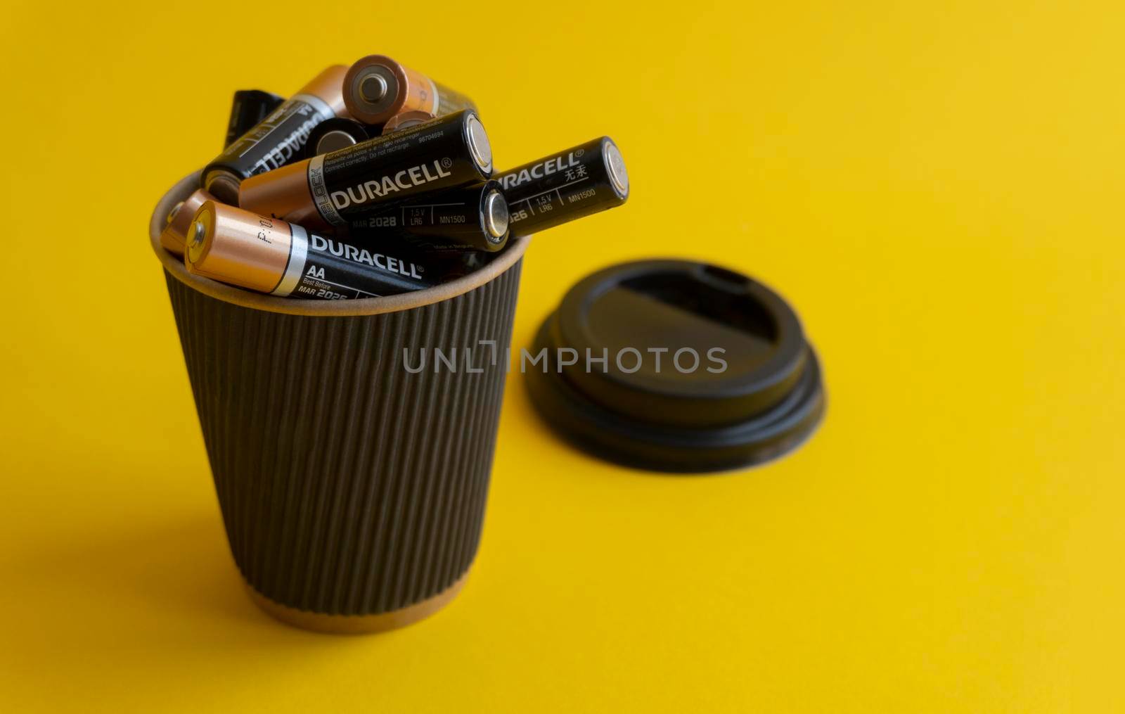 Closeup at duracell AA alkaline batteries in takeaway coffee cup by uveita