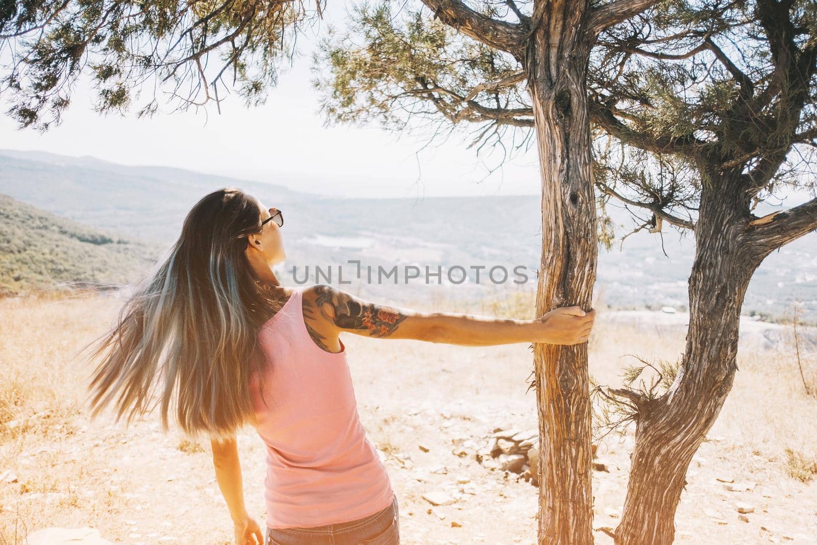 Woman standing near the tree on vacations. by alexAleksei