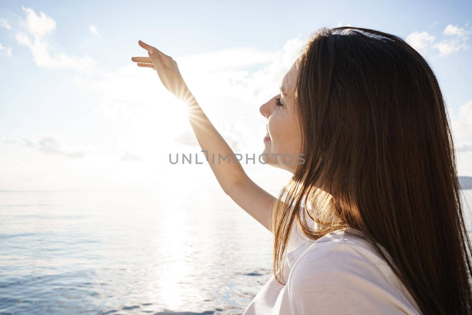 Portrait of young beautiful woman standing on boat against sea backgorund, close up