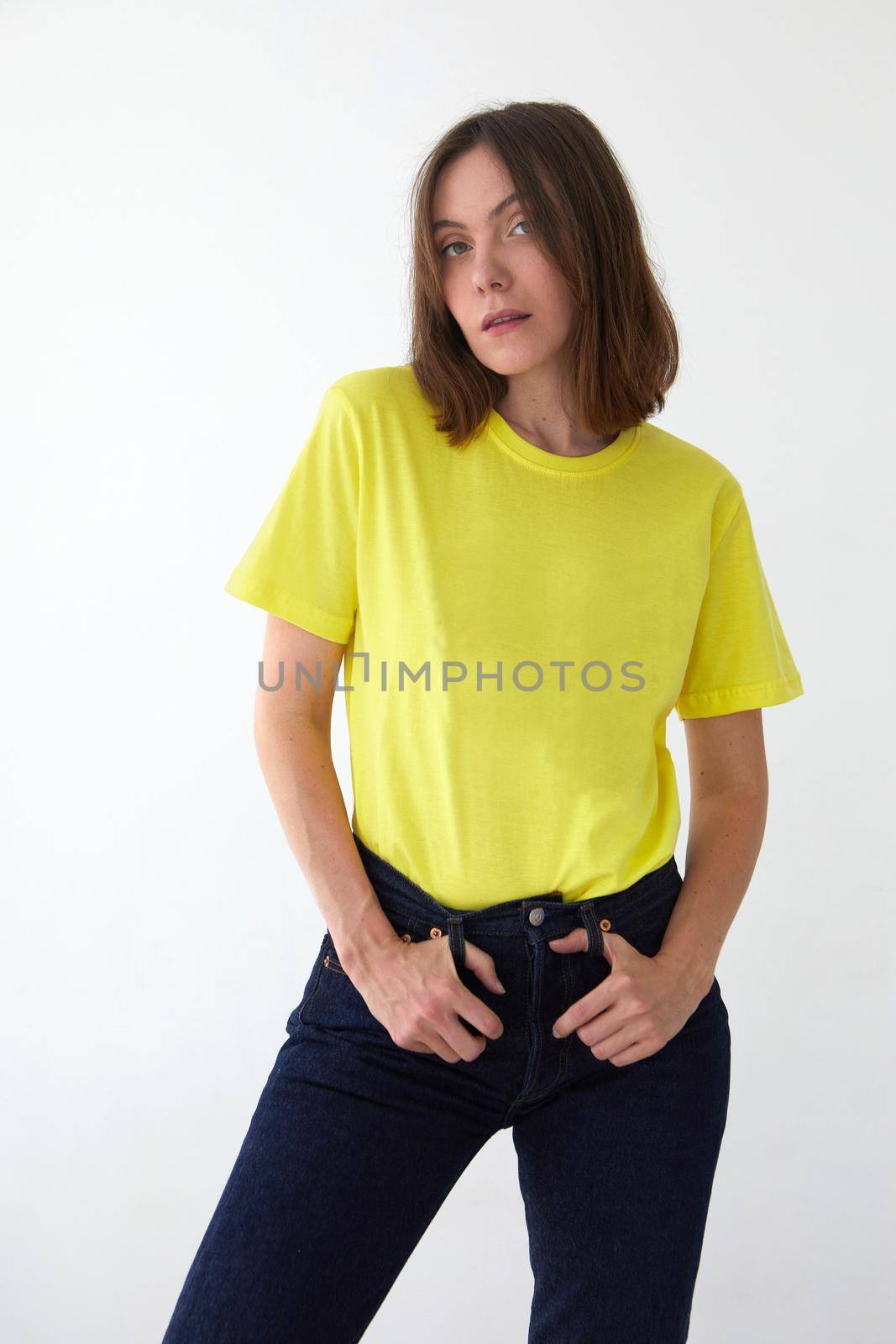 Young woman in yellow t shirt white background by Demkat