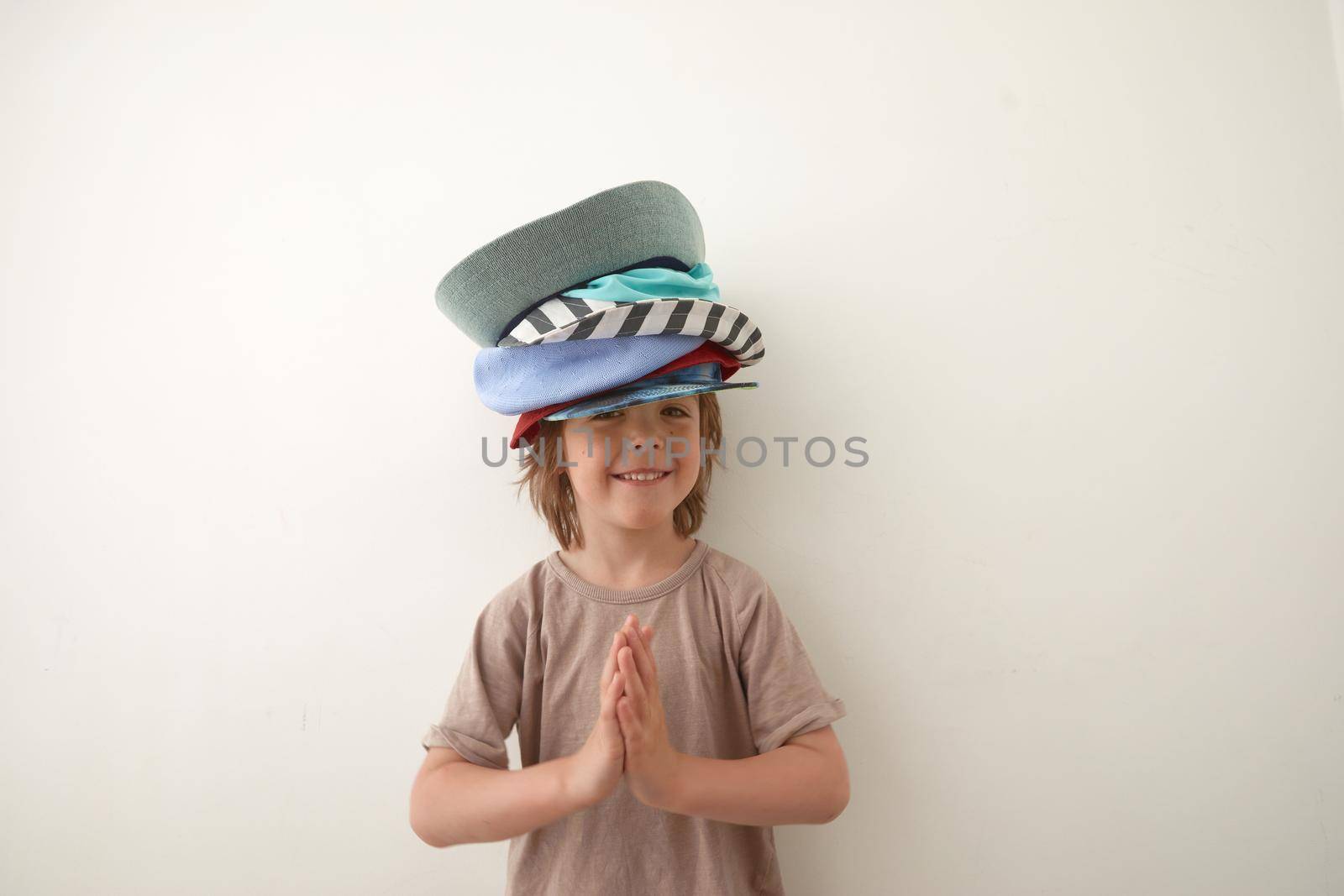 Adorable little boy wearing different hats on head by Demkat