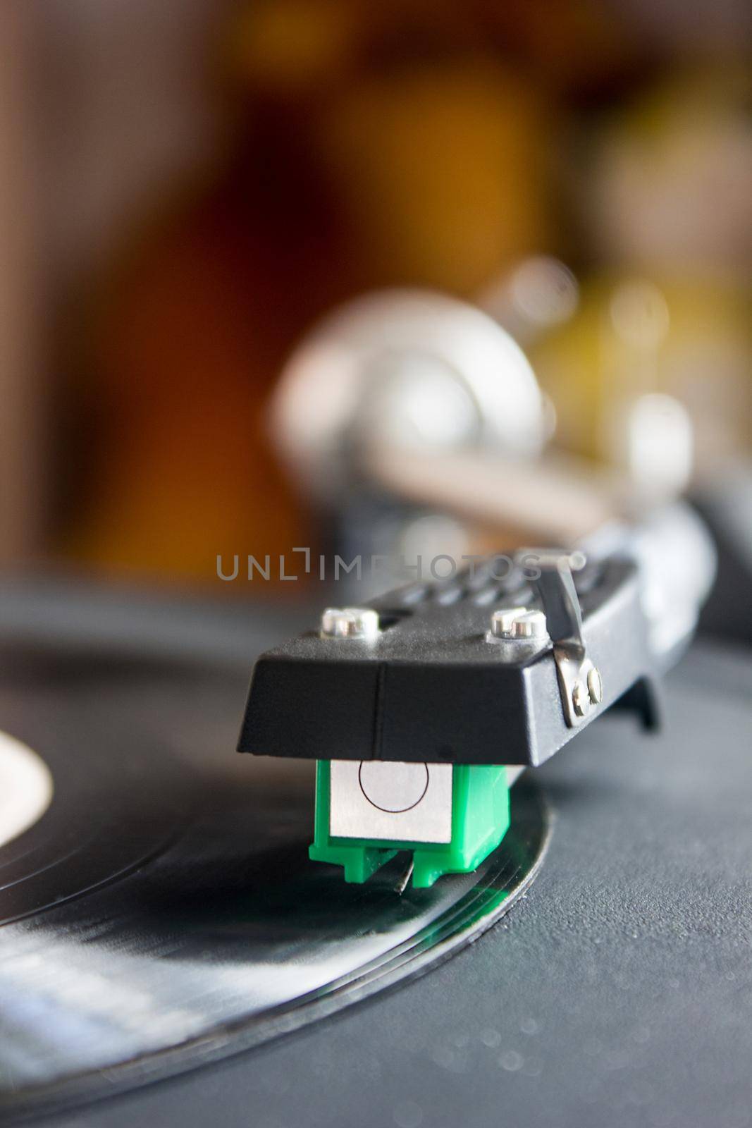 Turntable playing vinyl close up with needle on the record.