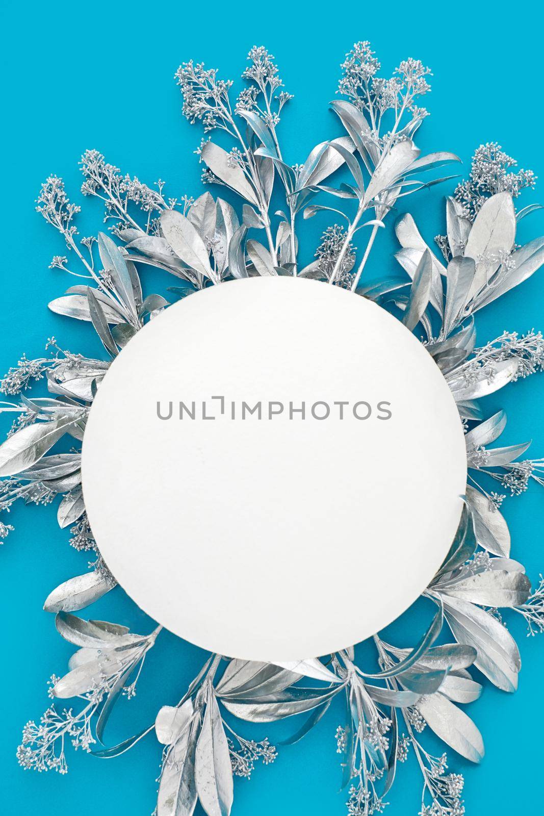 Blank paper card mockup with silver flowers. Holiday concept with place for text on a blue pastel background