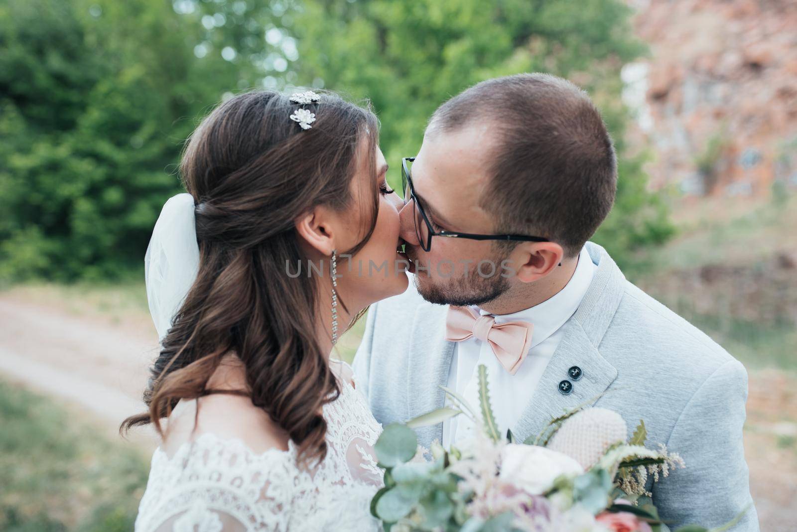 Wedding photography kiss bride and groom in different locations.