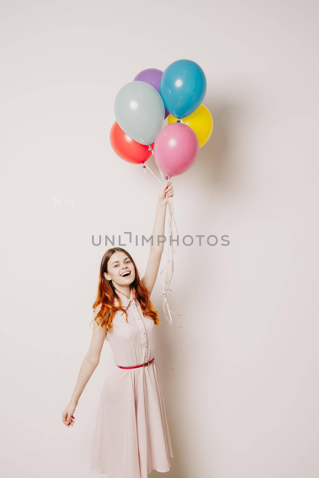 cheerful woman in a dress of colorful balloons. High quality photo