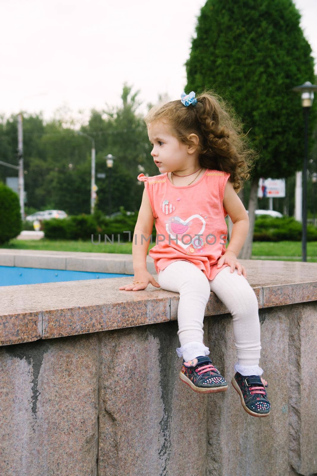 Little baby girl sitting on park by sharafizdushanbe