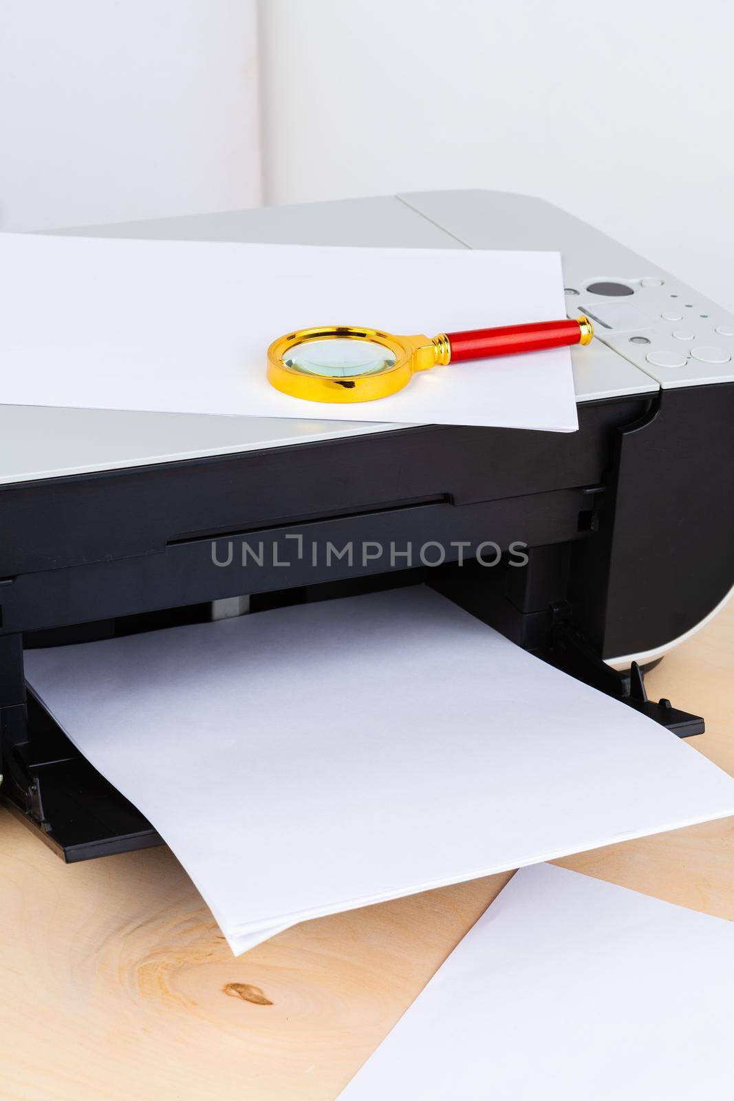 Office printer close up on a wooden table by Fabrikasimf